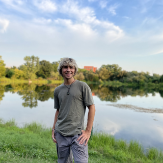 Mason Conway standing outside beside a lake